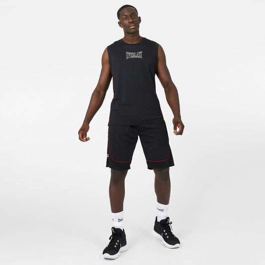 Man wearing a black sleeveless shirt and shorts with white socks and black sneakers on a white background view 1